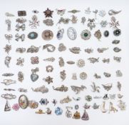 A large collection of vintage brooches including marcasite, enamel, Sphinx, etc