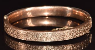 A c1910 9ct gold bangle with foliate decoration, 10.9g