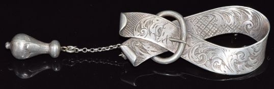 A 19thC silver cloak brooch in the from of a stylised buckle, with sprung clasp and chain,