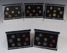 Five Royal Mint proof coin sets in deluxe cases 1983-1987