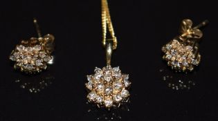 A 9ct gold pendant set with a cluster of diamonds, on 9k gold chain, with matching earrings, 4.3g,