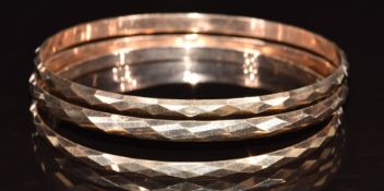Three 14k gold bangles with faceted decoration, 22.7g