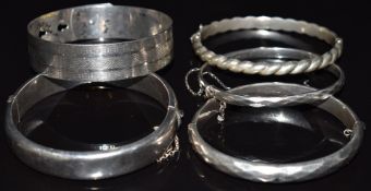 Five silver bangles, one by Charles Horner and two L and Co