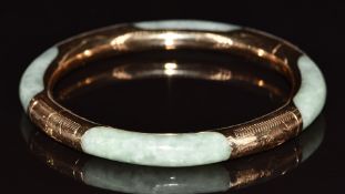A jadeite bangle with 14k gold mounts and clasp, 24.4g, diameter 5.6cm
