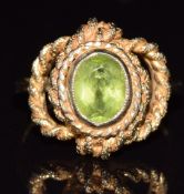 A 9ct gold ring set with an oval cut peridot in a rope twist setting, 5g, size O