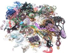 A collection of jewellery including garnet beaded necklace, silver ring, glass beaded necklaces,