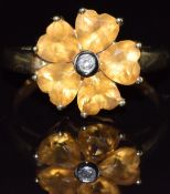 A 9ct gold ring set with five heart cut citrines and a diamond in a cluster, 2.2g, size N