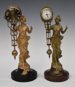 Two mystery clocks formed as ladies holding the pivot on which the clock swings, height of taller