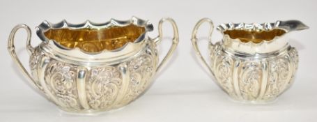 Victorian hallmarked silver bachelor's sugar bowl and milk jug, with embossed decoration and gilt