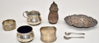 Hallmarked silver items comprising embossed pin dish, salt, mustard and pepper set with blue glass