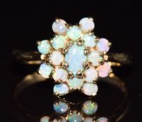 A 9ct gold ring set with a cluster of opals, 2.4g, size M