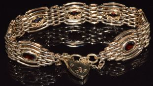 A 9ct gold gate bracelet set with oval cut garnets, with heart padlock clasp, 28.2g, 19cm long