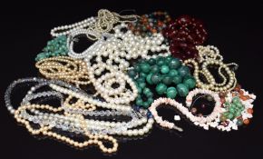 A collection of beaded necklaces including two strands of cherry amber, cultured pearl necklaces,