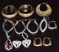 Three pairs of 9ct gold hoop earrings and seven single 9ct gold earrings, 16.3g