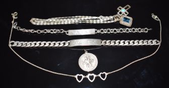 A collection of silver jewellery including two bracelets, two pendants, two chains and a St