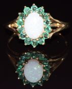 A 9ct gold ring set with opal surrounded by emeralds, 2.1g, size P
