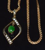 An 18ct gold necklace set with jade cabochon and diamonds on an 18ct gold chain, 6.5g, 40cm long