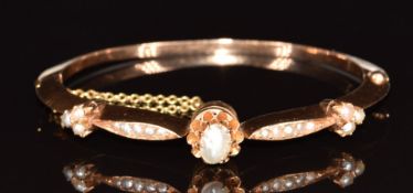 A 9ct gold bangle set with a split pearls and seed pearls, 14.7g