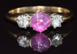 A 9ct gold ring set with a star ruby cabochon and two old cut diamonds, each approximately 0.2ct,
