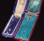 Edwardian 15ct gold stick pin set with seed pearls and a 9ct gold stick pin set with a garnet both