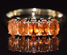 A 9ct gold ring set with five oval cut Malaia garnets, 2.6g, size N