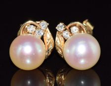 A pair of 14ct gold earrings set with a pearl and diamonds, 3g