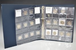 An album containing collectable £2 and 50p coinage, including Olympics, First World War, Isaac