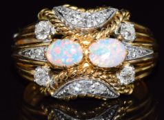 An 18ct gold ring set with two opal cabochons and old cut diamonds, 6.6g, size J