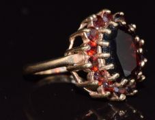 A 9ct gold ring set with a cluster of garnets, 5.2g, size M