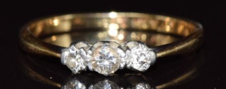 An 18ct gold ring set with three diamonds in a platinum setting, 1.6g, size M