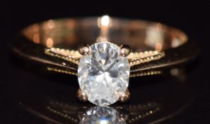 An 18ct gold ring set with an 0.58ct oval brilliant cut diamond, with GIA certificate, 2.7g, size I