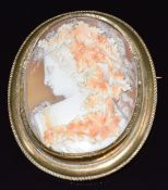 Victorian brooch set with a cameo depicting a lady with vines in her hair, signed to her shoulder,