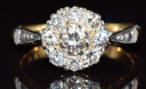 An 18ct gold ring set with diamonds in a platinum cluster setting, 3g, size J