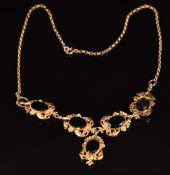 A 9ct gold necklace set with five oval cut garnets in a foliate setting, 23g, 47cm long