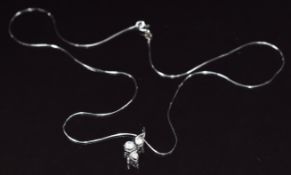 An 18k white gold necklace set with cubic zirconia on 18k white gold chain, 3.6g, 42cm long