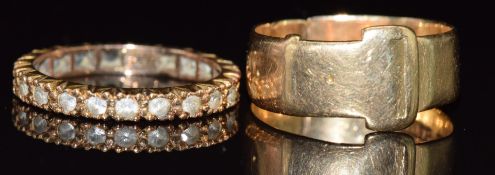 An 18ct gold buckle ring (4.6g)  and a 9ct gold eternity ring set with spinel, 2g