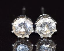 A pair of 18k white gold earrings, each set with a diamond of approximately 0.3ct, 0.9g
