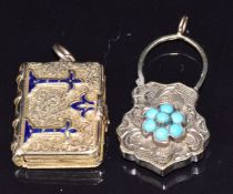 Victorian locket in the form of a book with engraved and blue enamel decoration opening to reveal