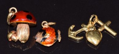 Three 18ct gold charms by Uno A Erre including a mushroom set with enamel, fish set with enamel, and