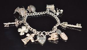A silver charm bracelet with 10 silver charms including Noah's Ark, four leaf clover, etc, 45g