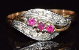 A 9ct gold ring set with three rubies and spinel, 1.8g, size N