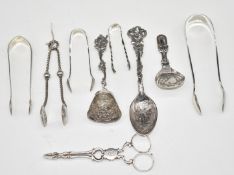 Five pairs of Georgian and later sugar tongs and nips, Georgian hallmarked silver caddy spoon,