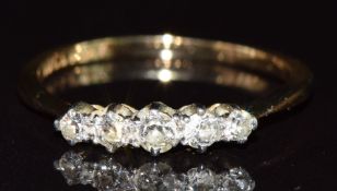 An 18ct gold ring set with five diamonds, 2.3g, size O/P
