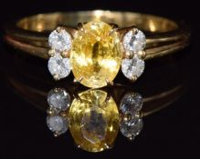 French 18ct gold ring set with a yellow sapphire of approximately 0.65ct and four diamonds, 2.9g,