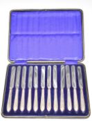 Cased set of twelve hallmarked silver handled knives, Sheffield 1918, with stainless steel blades,