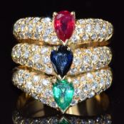 An 18ct gold ring set with a pear cut emerald, sapphire, and ruby, each approximately 0.7ct, the