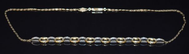 An 18ct gold bi-coloured necklace made up of mariners links and domed links set with diamonds,