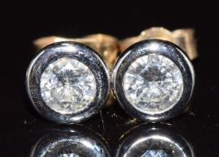 A pair of 18ct gold earrings, each set with a diamond of approximately 0.3ct, 1.2g