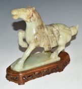 Chinese carved jadeite or similar hardstone horse with wooden base, 18cm tall.