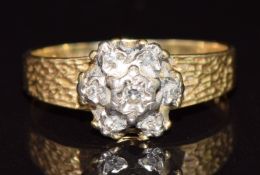A 9ct gold ring set with diamonds in a cluster with textured shoulders, 2.8g, size L